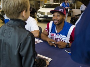 Alouettes defensive back Daryl Townsend meets a fan at a meet-and-greet event at Performance Ford Thursday. (GABRIELLE SMITH/The Windsor Star)