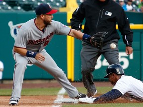 Minnesota's Trevor Plouffe, left, tries to get a tag down at third base on Anthony Gose of the Tigers during the fifth inning at Comerica Park Thursday. (Photo by Gregory Shamus/Getty Images)