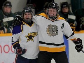 St. Anne's Cole Butler, left, is congratulated by General Amherst's Ryan Wismer in an all-star game against the Lambton/Kent All Stars Tuesday at South Windsor Arena. (NICK BRANCACCIO/The Windsor Star)