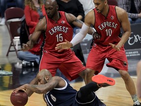 WINDSOR, ON. April 15, 2015 -- Halifax Rainmen Tyron Watson keeps dribbling after being knocked to the floor against Windsor Express Quinnel Brown, left, and Kevin Loiselle in NBL Canada league championship final at WFCU Centre Wednesday April 14, 2015. (NICK BRANCACCIO/The Windsor Star)