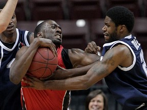 Windsor Express Chris Commons, centre, is fouled by Halifax Rainmen Nigel Spikes, left, and Jermaine Dailey in NBL Canada Game One of the league championship final at WFCU Centre Wednesday April 14, 2015. (NICK BRANCACCIO/The Windsor Star)