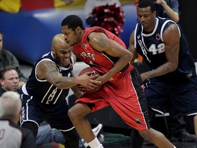 Halifax Rainmen Tyron Watson, left, and Nigel Spikes battle Windsor Express forward Jamarcus Ellis for a rebound in Game One of the NBL Canada final at the WFCU Centre.