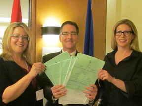 Windsor West MP Brian Masse is shown with Heather MacDonald-Ellis  (left) and Jessica John (right) before heading to the House of Commons Monday April  20, 2015 where Masse presented their petition with more than 9,000 signatures. The two Ford workers started a petition that is seeking a national auto strategy. (Handout)
