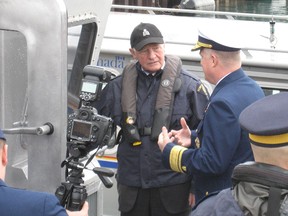 Canadian Governor General David Johnston gets briefed by USCG Rear Admiral Fred Midgette aboard a U.S. Coast Guard vessel on Thursday, April 30, 2015. (Handout)