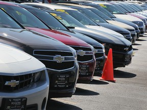 Chevrolet and Buick cars are offered for sale in this file photo. (Photo by Scott Olson/Getty Images)