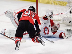 Montreal Canadiens goalie Carey Price sprawls in front of a leaping Ottawa Senators' Mika Zibanejad (93) during third period NHL playoff action in Ottawa, Sunday, April 26, 2015. THE CANADIAN PRESS/Adrian Wyld