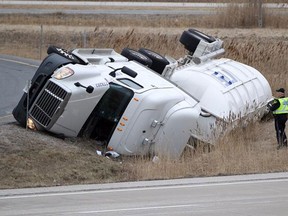 A tanker truck on its side by the eastbound lanes of Highway 401 near County Road 42 in Lakeshore on April 7, 2015. (Jason Kryk / The Windsor Star)