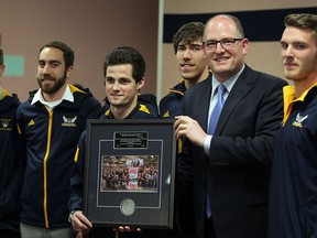 University of Windsor Lancers CIS National Champion men's track and field team were honoured by Windsor Mayor Drew Dilkens, 2nd right, Monday April 20, 2015. Associate coach Brett Lumley, left, and five members of the team accepted the award and posed for photographs at council. (NICK BRANCACCIO/The Windsor Star)