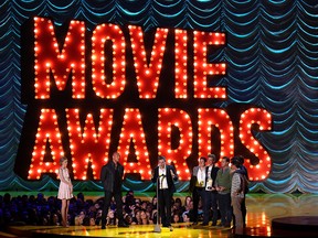 John Green, center, and the cast and crew of “The Fault in Our Stars” accept the award for movie of the year at the MTV Movie Awards at the Nokia Theatre on Sunday, April 12, 2015, in Los Angeles. (Photo by Matt Sayles/Invision/AP)