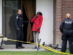 Eyewitness Mary Ojullo demonstrates to Windsor Police investigators how and where a man was stabbed at 445 Glengarry Avenue Wednesday April 22, 2015. (NICK BRANCACCIO/The Windsor Star)