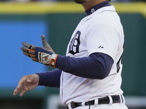 Detroit Tigers first baseman Miguel Cabrera tosses his glove after catching the fly out his by New York Yankees' Jacoby Ellsbury during the first inning of a baseball game, Tuesday, April 21, 2015, in Detroit. (AP Photo/Carlos Osorio)