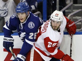 Detroit's Landon Ferraro, right, is checked by Tampa Bay's Matt Carle during Game 1 of the Wings-Lightning series in Tampa Bay. (Dirk Shadd/Tampa Bay Times via AP)