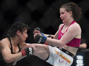 Windsor's Randa Markos, left, trades blows with Aishling Daly, right, from Ireland, during their UFC 186 fight in Montreal, Saturday, April 25, 2015. THE CANADIAN PRESS/Graham Hughes