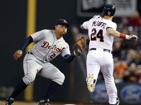 Detroit Tigers first baseman Miguel Cabrera, left, reaches out to tag Minnesota Twins’ Trevor Plouffe in the fourth inning of a baseball game, Monday, April 27, 2015, in Minneapolis. (AP Photo/Jim Mone)