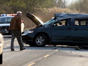 In this file photo, the coroner makes observations at the scene of a double fatal rollover involving a Honda minivan on Hwy. 3 west of Morse Road where OPP are investigating April 29, 2015. (NICK BRANCACCIO/The Windsor Star)