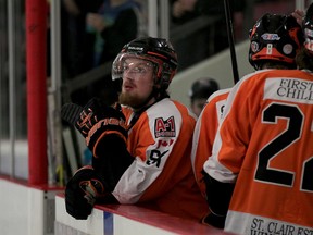 Essex 73's Brad Carroll and Tyler Turner, right, head for the dressing room as a teammate gazes onto ice after a losing effort against Port Hope Tuesday April 28, 2015. (NICK BRANCACCIO/The Windsor Star)