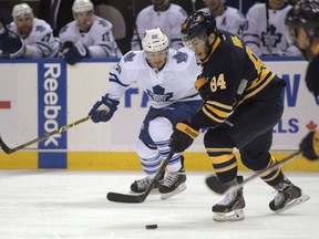 Buffalo's Philip Varone, right, is chased by Toronto's Zach Sill during the second period Wednesday in Buffalo.  (AP Photo/Gary Wiepert)
