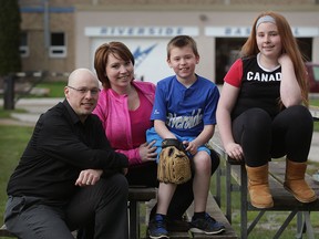 Joshua LeClair, left, and his wife Stepanie LeClair, sit with their children Jonas, 9, and Jaycie, 12, at Riverside Baseball Centre where Jonas had an indoor baseball practice April 30, 2015. (NICK BRANCACCIO/The Windsor Star)