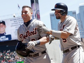 Detroit Tigers’ James McCann, left, is congratulated by Nick Castellanos after his inside-the-park home run off Minnesota Twins pitcher Aaron Thompson in the sixth inning of a baseball game, Wednesday, April 29, 2015, in Minneapolis. (AP Photo/Jim Mone)