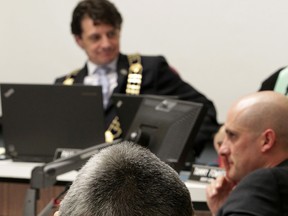 In this file photo, Amherstburg councillor Leo Meloche holds his head while discussing recreational facility fees during Town of Amherstburg special council meeting March 31, 2015. Councillor Jason Lavigne, right, and Mayor Aldo DiCarlo join in the debate. (NICK BRANCACCIO/The Windsor Star)