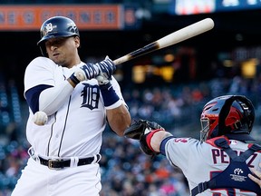 Victor Martinez of the Detroit Tigers is hit by a pitch from Cleveland Indians Danny Salazar as Roberto Perez of the Cleveland Indians works behind the plate during the first inning at Comerica Park on April 24, 2015 in Detroit, Michigan. (Photo by Duane Burleson/Getty Images)