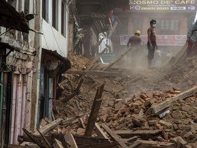 Volunteers and quake emergency team members clear debris from one of the UNESCO World Heritage site temples in Basantapur Durbar Square on April 28, 2015 in Kathmandu, Nepal. (Omar Havana/Getty Images)