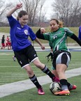 Assumption's Ella Hooper, left, battles for the ball during a 3-2 loss against Herman in high school girls soccer Tuesday at Alumni Field. (GABRIELLE SMITH/Special to The Windsor Star)