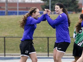 Assumption's Victoria Cope, left, celebrates with Emma Rothera after scoring a goal in a 3-2 loss against Herman Tuesday at Alumni Field. (GABRIELLE SMITH/Special to The Windsor Star)
