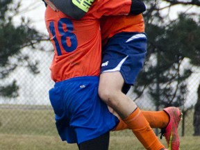 Sandwich's Dante Ussoletti, right, celebrates with Edwin Cipkar after scoring the winning goal against Cardinal Carter in high school boys soccer Wednesday. (GABRIELLE SMITH/The Windsor Star)