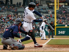 Detroit's Ian Kinsler hits a fourth-inning single as Minnesota catcher Kurt Suzuki waits for the pitch Wednesday at Comerica Park. (Photo by Gregory Shamus/Getty Images)