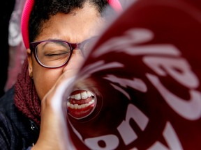 Latoya Watson of Washington, with Planned Parenthood, cheers during a rally outside the Supreme Court in Washington, Wednesday, March 4, 2015, as the court was hearing arguments in King v. Burwell, a major test of President Barack Obama's health overhaul which, if successful, could halt health care premium subsidies in all the states where the federal government runs the insurance marketplaces. (AP Photo/Andrew Harnik)