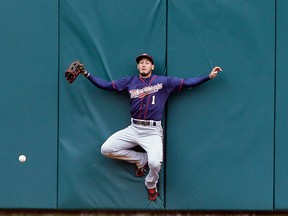 Minnesota Twins center fielder Jordan Schafer misplays the triple hit by Detroit Tigers' Yoenis Cespedes during the sixth inning of an opening day baseball game in Detroit, Monday, April 6, 2015. (AP Photo/Carlos Osorio)