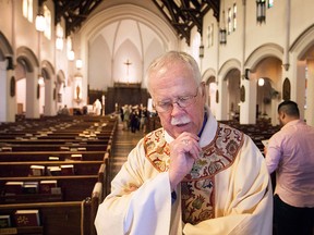 Father Don McLeod speaks about the announcement that Assumption Church will remain closed after a $10 million donation fell through, while at Our Lady of Assumption Parish, Sunday, April 19, 2015.  (DAX MELMER/The Windsor Star)