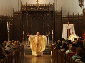 Father Don McLeod holds mass at Our Lady of Assumption Parish, Sunday, April 19, 2015.  (DAX MELMER/The Windsor Star)
