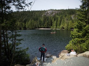 Two men sit on a canoe while fishing on Petgill Lake near Squamish, B.C., on Saturday, April 18, 2015. THE CANADIAN PRESS/Darryl Dyck