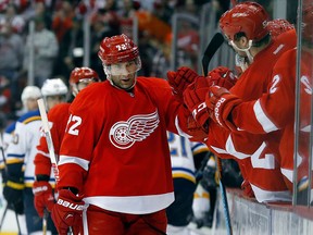Detroit Red Wings right wing Erik Cole, left, celebrates his goal against the St. Louis Blues in the third period of an NHL hockey game in Detroit, Sunday, March 22, 2015. (AP Photo/Paul Sancya)