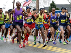 From left, Yemane Adhane Tsegay of Ethiopia, Wesley Korir of Kenya, Tadese Tola of Ethiopia, Meb Keflezighi of San Diego, Lelisa Desisa of Ethiopia, Lusapho April of South Africa, and Nicholas Arciniaga of Flagstaff, Ariz., leave the start line of the Boston Marathon, Monday, April 20, 2015, in Hopkinton, Mass. (AP Photo/Stephan Savoia)