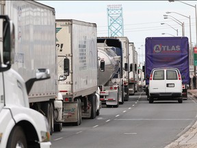 Trucks back up to highway 401in Windsor, Ontario during the closure of the Ambassador Bridge following a vehicle fire. (JASON KRYK/The Windsor Star)