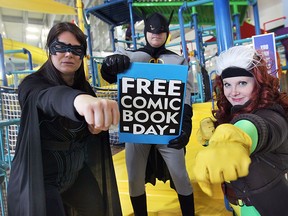 To mark the upcoming worldwide Free Comic Book Day on May 2, comics will be given away at the Adventure Bay Water Park in Windsor, ON. Some of the superheroes that will be handing out the comic books pose for a photo on Thursday, April 23, 2015, to promote the event. Batwoman, Batman and Rogue are shown at the water park.  (DAN JANISSE/The Windsor Star)