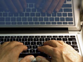 The hands of a computer user in a 2013 file photo. (Damian Dovarganes / Associated Press)