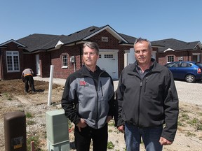 Rob Mathers, from Rob Mathers Realty Ltd. and Ben Klundert, president of BK Cornerstone and president of the Windsor-Essex Home Builders Association stand next to home under construction on Arpino Avenue in Windsor, Ontario on April 24, 2015.  (JASON KRYK/The Windsor Star)