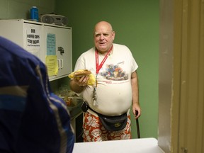 Raymond Poisson hands out to-go meals at Windsor's Downtown Mission, Thursday afternoon. (GABRIELLE SMITH/Special to The Star)