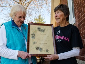 Gail Griesinger, left, and Madonna Beaudette display a wedding certificate from 1911. Beaudette's husband found the frame at an auction and through the power of social media, found Griesinger, who has ties to the couple it originally belonged to. (GABRIELLE SMITH/Special to The Windsor Star)
