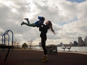 Maya Novakovic catches her jumping nephew, Kaiden Angel, 4, at Great Western Park, Tuesday afternoon. (GABRIELLE SMITH/The Windsor Star)