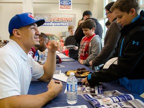 Tyrone Crawford meets fans at a meet-and-greet event held at Performance Ford, Thursday. Crawford, defensive end for the Dallas Cowboys, was among the four CFL and NFL players at the event, meeting fans and promoting Windsor's Finest Football Academy. GABRIELLE SMITH/Special to The Windsor Star