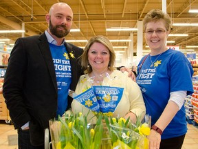 Jeff Casey, left, cancer survivor and activist, and Paula Talbot and Judy Lund of the Canadian Cancer Society are pictured in front of their daffodil display at Real Canadian Superstore, Friday. Canadian Cancer Society members and volunteers will be selling daffodil pins and live flowers this month to raise money for cancer research and show support for Canadians living with cancer. GABRIELLE SMITH/Special to The Windsor Star