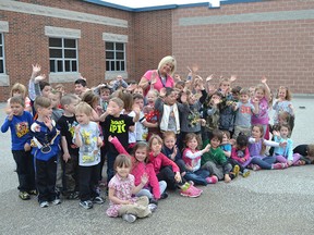 Early childhood educator Cathy Meloche, centre, is surrounded by junior and senior kindergarten pupils at Holy Name Catholic elementary school in Essex. The school was chosen as one of 10 finalists from across Canada in the Majesta Tree of Knowledge contest with it’s top prize of $20,000. (JULIE KOTSIS/The Windsor Star)