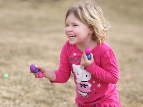 Juniper Scott, 5, is all smiles as she collects Easter eggs at the National Service Dogs Easter Egg Hunt for Dogs and their Families at Malden Park, Friday, April 3, 2015.  (DAX MELMER/The Windsor Star)