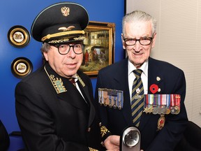 Dr. Roman Maev presents veteran Larry Costello with a commemorative clock. “He’s doing a fantastic job and I mean that from all my heart,” the Canadian naval vet says of Maev.
Photo by Ed Goodfellow