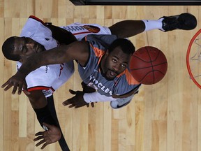 Windsor's Chris Commons, left, scores over Moncton's Stanley Robinson as the Windsor Express host the Moncton Miracles at the WFCU Centre, Sunday, Dec. 8, 2013.  Windsor defeated Moncton 115-101.  (DAX MELMER/The Windsor Star)